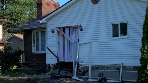 Driver charged after crash into house sends four people to hospital