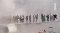 Watch: Passengers seen on wing of plane after jet catches fire