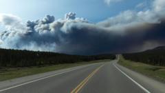 Thousands evacuate from fast-moving fires in Canada