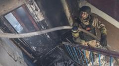Buildings burn as another wave of Russian attacks hits Ukraine