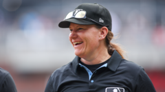Standing ovation as first female umpire for Major League Baseball takes to the pitch