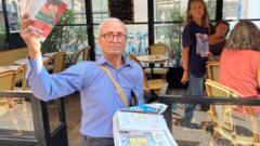 France’s last newspaper hawker gets Order of Merit from his old customer – President Macron