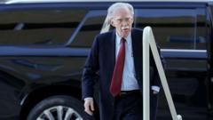 Bolton surrenders to face charges of sharing classified information