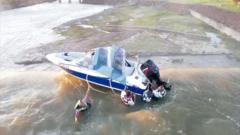 Watch: Four men rescued from boat teetering on dam edge