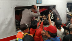 Rescuers race to free survivors trapped inside train after fatal Indonesia crash