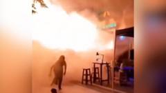 People flee Bangkok bar as huge flames shoot out from doorway
